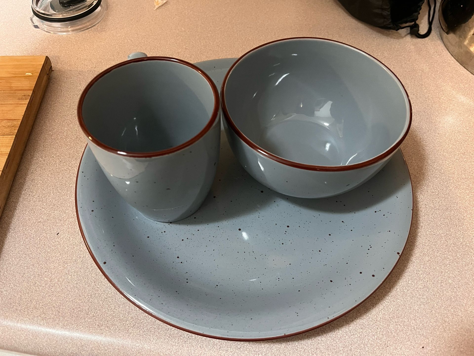 A Set Of 4 cups, Plates, And Bowls