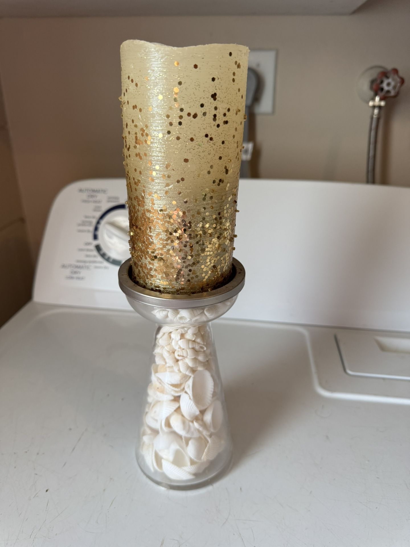 Shell filled candle stick holder with battery operated candle batteries not included