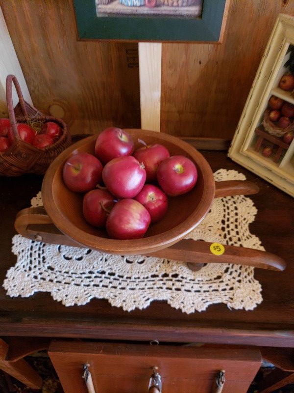 Wooden wheel barrel with as apples