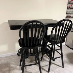black tall table with 3 chairs 