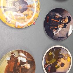 collection of decorative collector plates featuring illustrations by Norman Rockwell, 