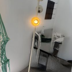 mid-century Danish-style floor lamp with multiple adjustable shades.