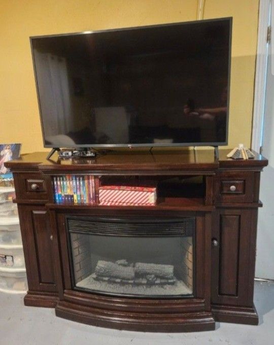 Electric fireplace with wood cabinet,it Works Very Good/measurements/ 64x19x43/ Cash Only $150