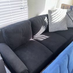 Black Couch With Two Pillows 