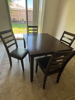 Dark wood table with 4 chairs