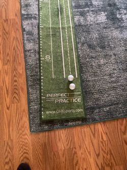 NICE PERFECT PRACTICE PUTTING MAT 9’ LONG BY 16” WIDE, FOLDS UP FOR STORAGE IN GREAT SHAPE!!!