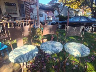 3 metal bar chairs with rounded bottom , have metal backs with coffee cop engraved on seat back