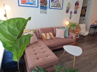 Dusty-pink tufted sectional sofa with chaise