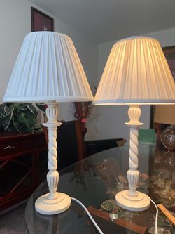 Vintage table lamp with a fluted glass column and crystal-style base. Includes a white pleated fabric shade for a classic look. Gently used with minor