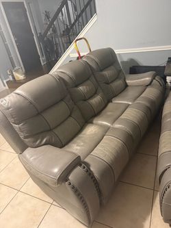 Gray Leather Reclining Sofa with Nailhead Trim