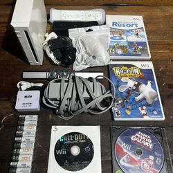Wii w/ all cables, 2controllers, 3nunchucks, 4 games