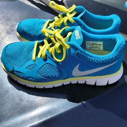 Ladies Nike blue and neon yellow running shoes size 7.