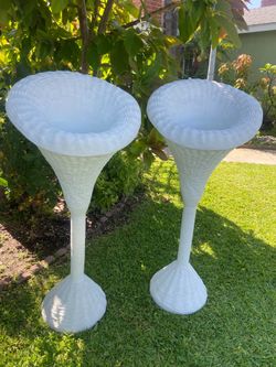 Faux rattan floral arrangement stands.