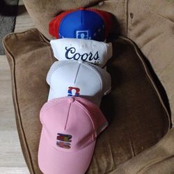 4 brand New Snapback FIFA Hats, One Is A White Fifa, One Is A red And Blue FIFA, One Is A Pink FIFA And the last one is a White coors FIFA Hat.