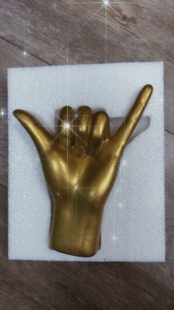 Golden hand sculpture - hang loose