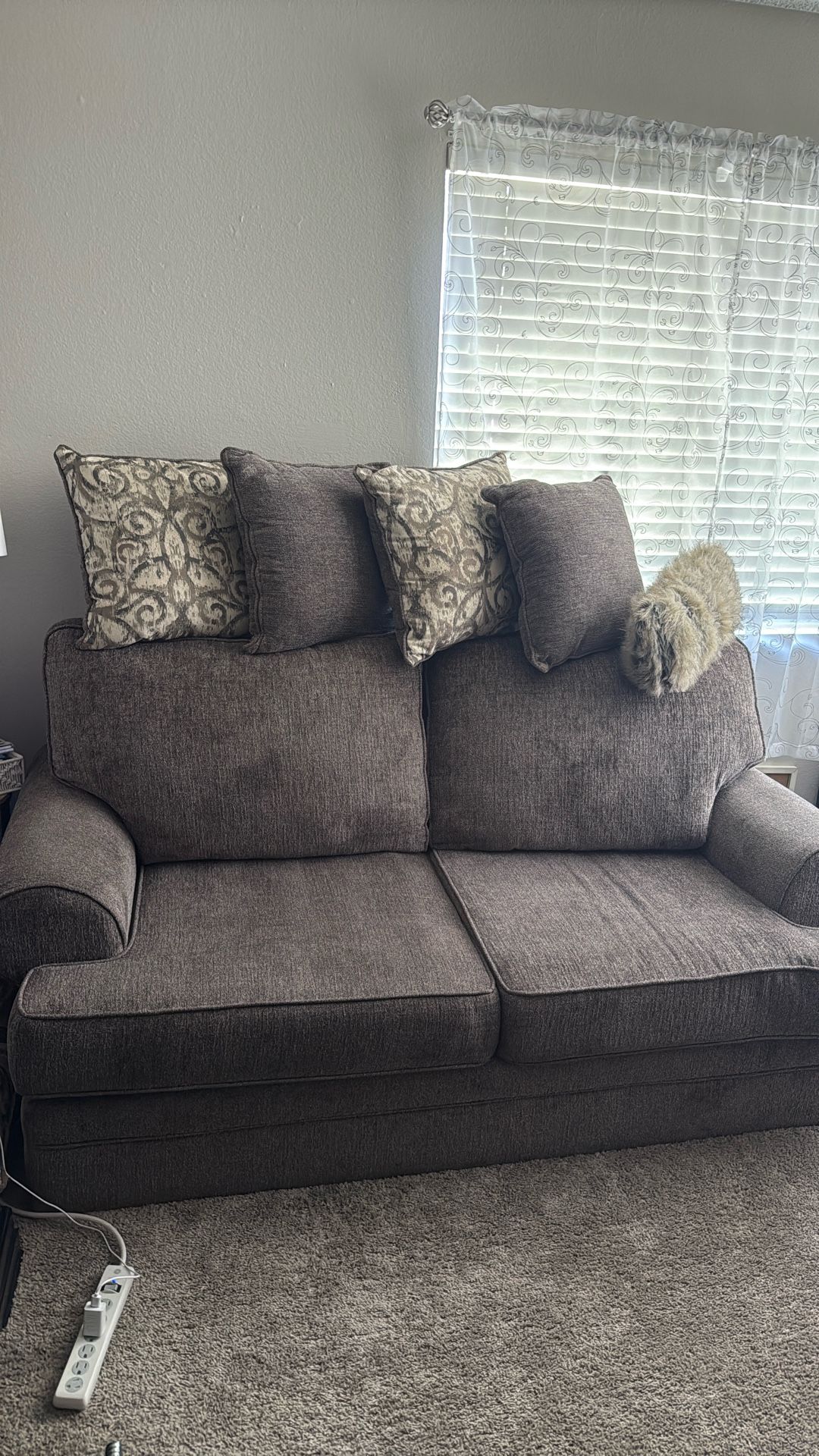 2 to 3 person couch and pillows.