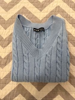 Light blue cable-knit V-neck sweater vest