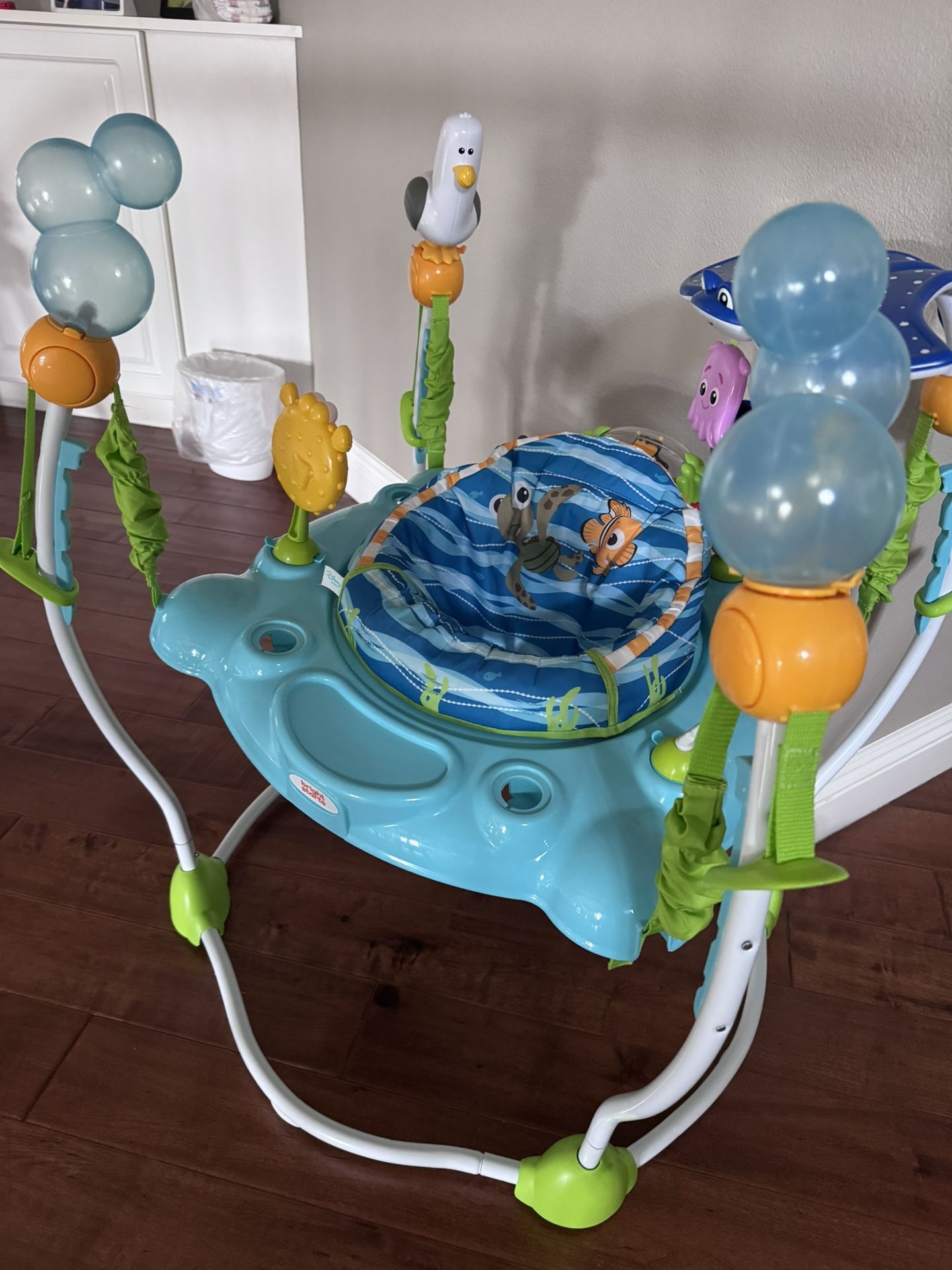 Bright Starts Disney Baby Finding Nemo Sea of Activities Baby Activity Center Jumper with Interactive Toys, Lights, Songs & Sounds, 6-12 Months (Blue