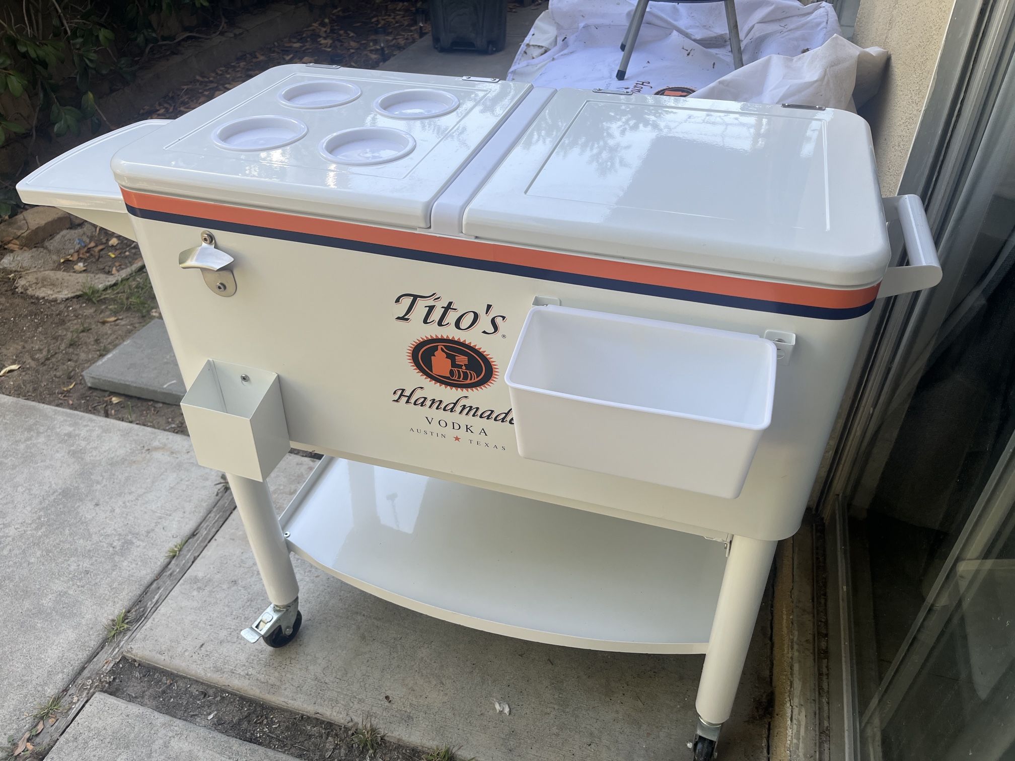 Tito’s Vodka rolling cooler with canvas cover slip