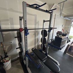 Squat Rack With Weights, Bench, and Mats