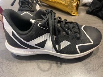 Woman’s New Balance black softball metal cleats Size 8