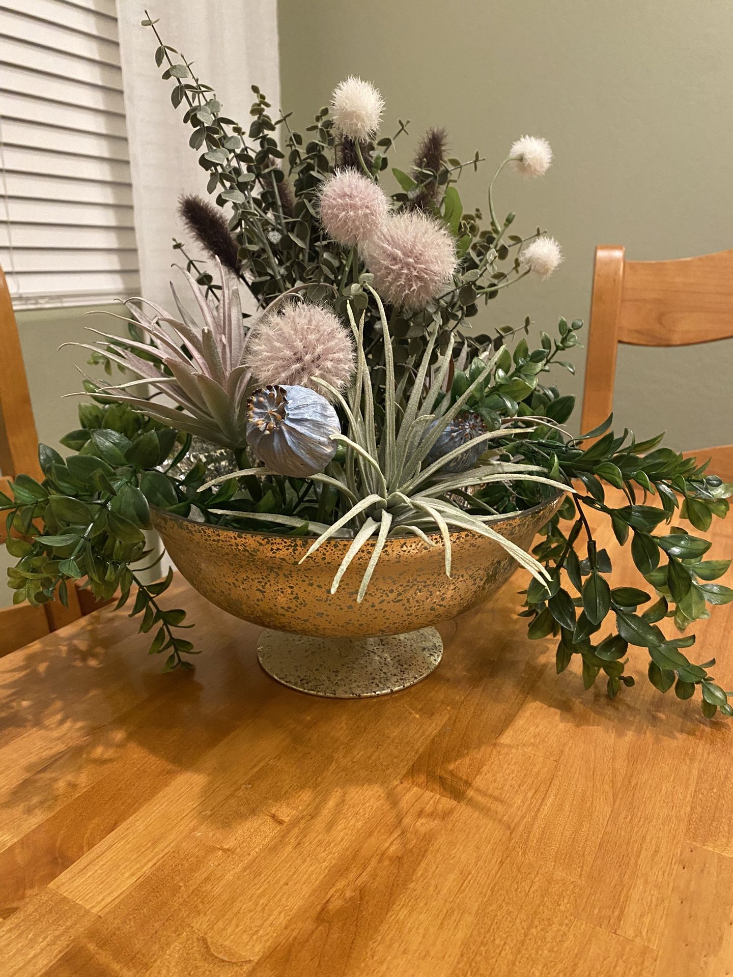 Faux plants / succulents/ poppyseed/ thistle/ cattails mix in gold painted glass pedestal bowl.