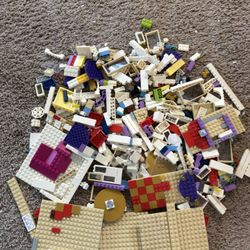 Large lot of LEGO building blocks in good condition. Includes base plates, bricks, windows, doors, decorative pieces, and various colors. Perfect for 