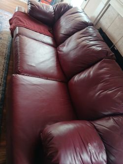 Two Piece Burgundy Leather Couch Set Has 4 Small Rips