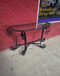 Glass with metal entryway table, tiny chip on the back part of the glass, barely noticeable,  superficial scratches on top from where keys were kept