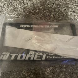 tomei license plate and badge