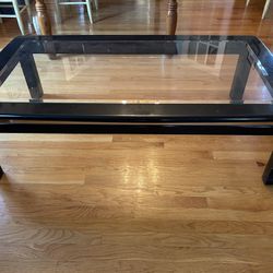 1970s Lacquer Coffee Table with beveled glass top and gold metal trim around edge