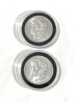 About un circulated sealed in capsules 1897 and 1898 Morgan Silver dollars. These are valued at $101 each on US Coin book.