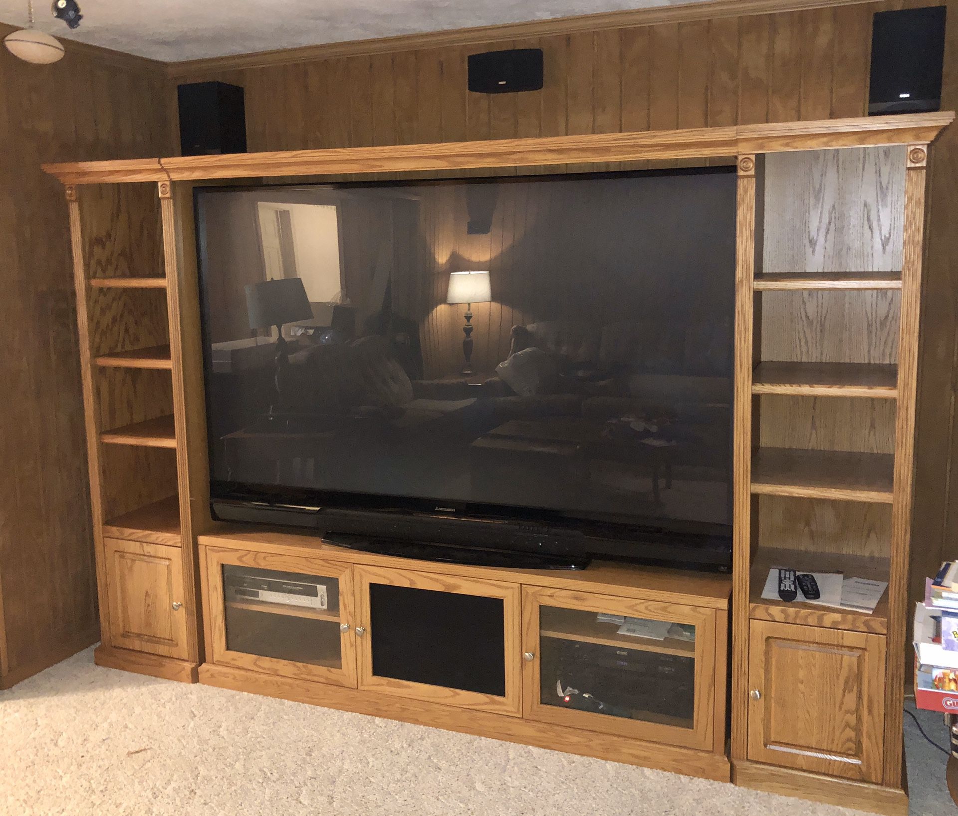 80” TV with surround sound and wooden cabinet