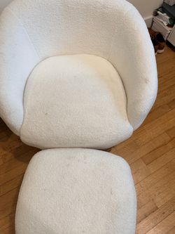 White bouclé accent chair with foot stool