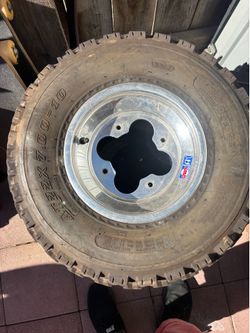 Quad 1 front wheel and tire and 2 rear tires