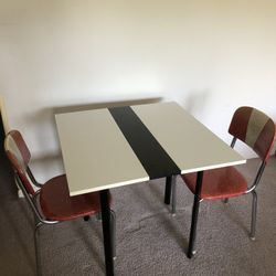 wooden table and two chairs