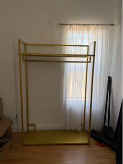 Golden metal closet system. Painted gold. & golden metal clothing rack.