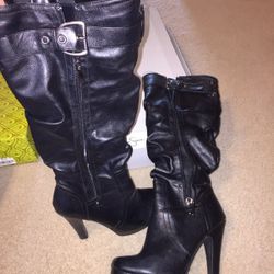 Pair of black leather buckled heeled slouchy boots. size 6.5. normal wear