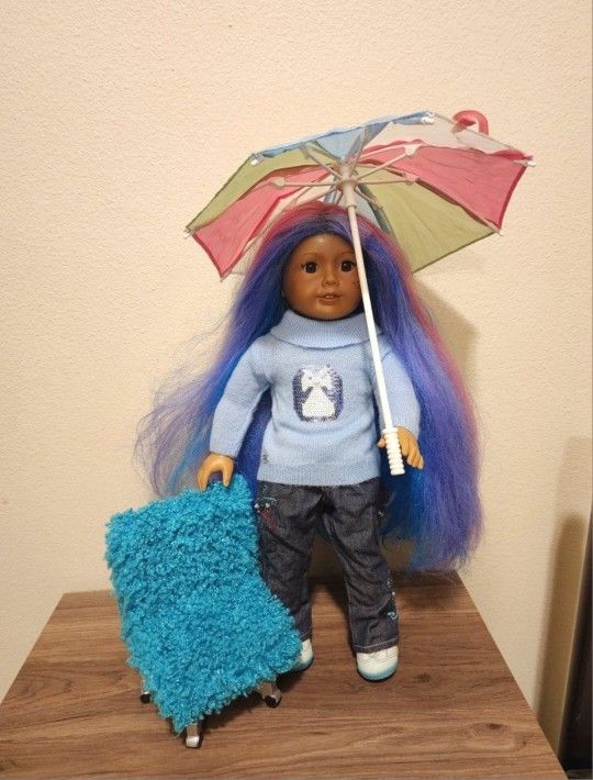 American Girl Doll With Chair and Umbrella. Has been played with Good Condition. It is possible that the hair is from a different doll.