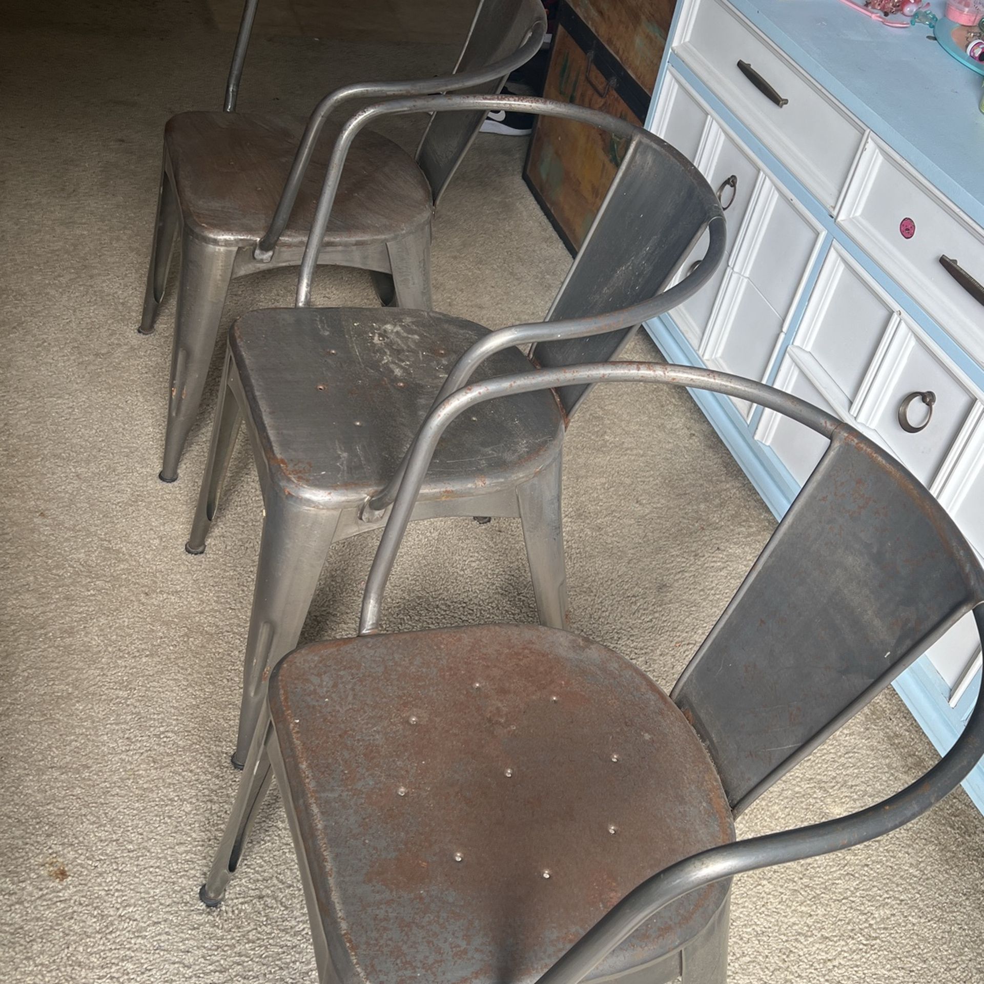 three metal chairs