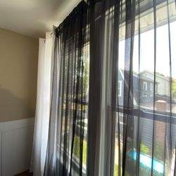  2 white curtain  panels and 2 Black Sheer Curtains  84 inch long 