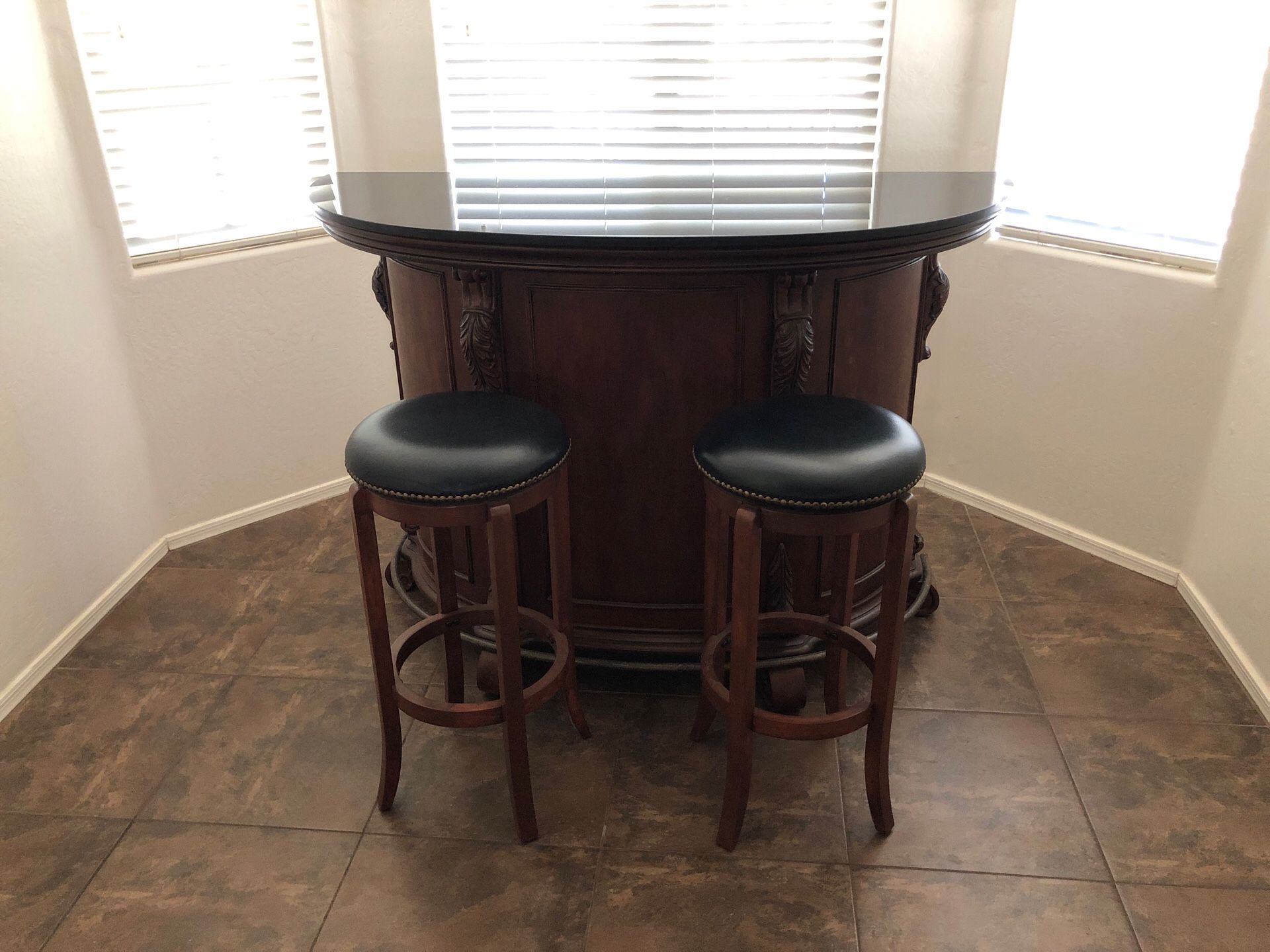 Bar with matching swivel top stools. Granite top and plenty of storage.