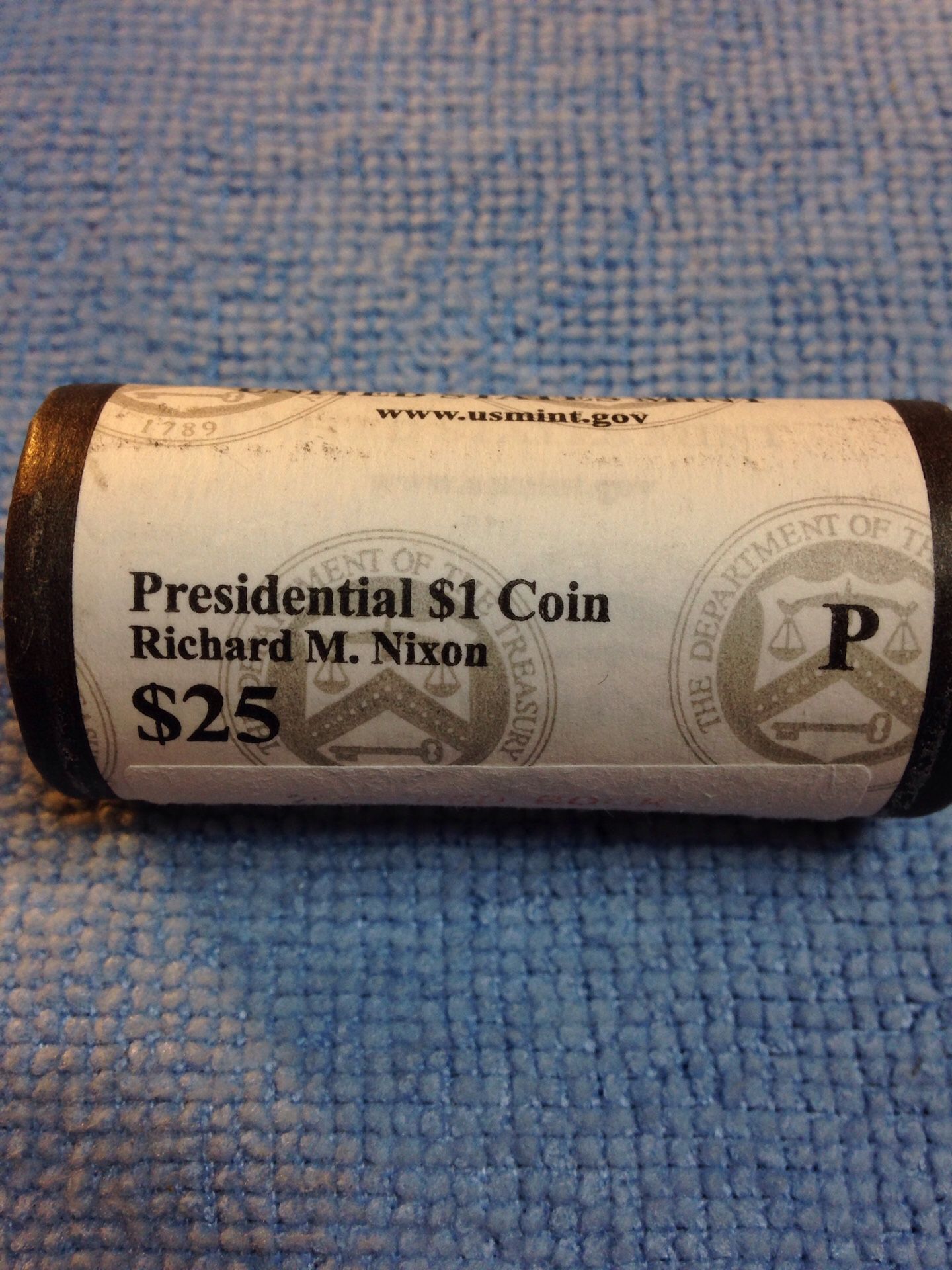 Presidential 1 dollar coin mint roll unopened unsearched.