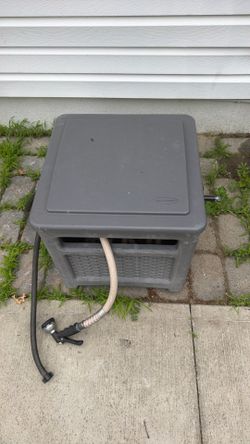 Suncast resin hose reel/hose hideaway with a garden hose included.