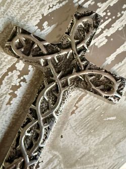Silver-Toned Crown of Thorns Metal Wall Cross   Metallic silver-toned wall cross has a raised crown of thorns design. This piece is made of a cast alu
