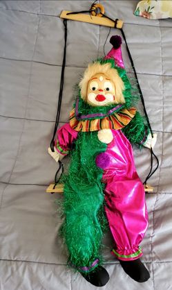Vintage marionette clown popet on swing.