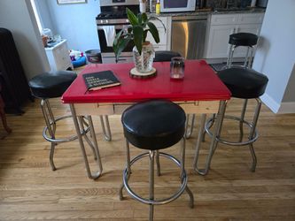 Vintage high table with barstools has drawers for silverware and the side.leaf pulls out