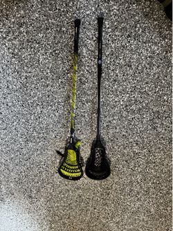Two Lacrosse Sticks Under Armour and Warrior