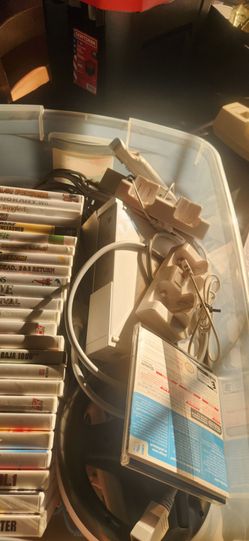 Wii with 27 games, 3 steering wheels, Mario Cart, cabella gun, and more.