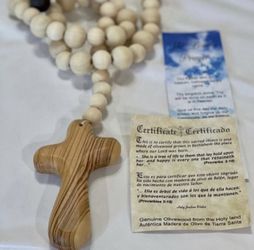 Olive wood cross on wood bead looped garland.  Cross comes with certificate of authenticity.